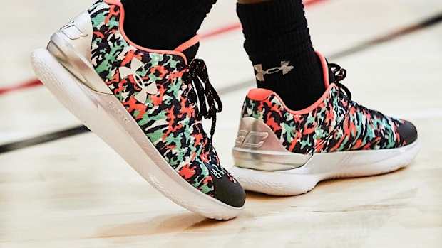 View of black, green, and red Curry One Low shoes.